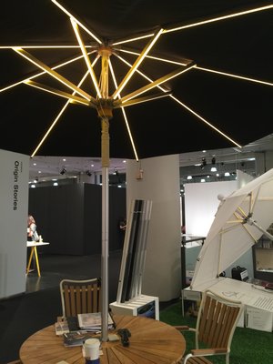 An illuminated outdoor umbrella with dimmer. MARSHALL WATSON