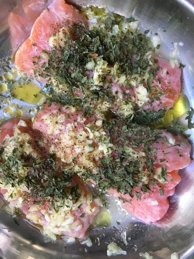 Salmon tails, marinating before grilling.