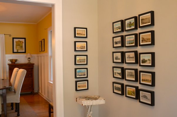 Old postcards of local sights + simple, inexpensive frames = foyer magic. CHRIS ARNOLD