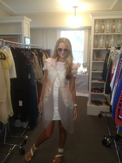 VH1 host Jackie Miranne tries on a fringe jacket by Alicia Reina. COURTESY CARMEN ADRIANA