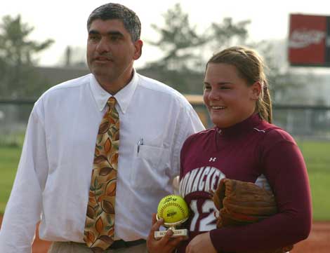 Jessie Stavola receives a commemorative game ball from East Hampton Athletic Director Joe Vasile-Cozzo.