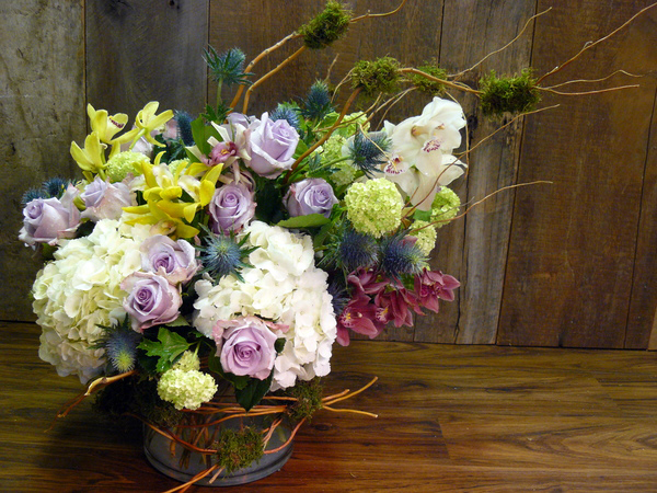 One arrangement by Robin Preiato of Thorn Bird Floral Boutique in Water Mill; featuring hydrangea, roses, thistle, cymbidium orchids, viburnum, moss and curly willow. COURTESY ROBIN PREIATO