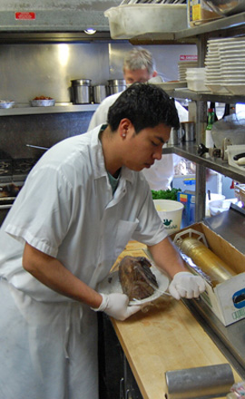 Hector Franco preps for the kitchen for the lunch crowd. BRIAN BOSSETTA