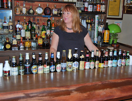 Nancy Klavis and the many beers served at the restaurant. BRIAN BOSSETTA