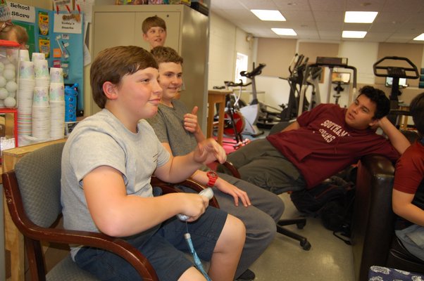 Logan Edler, left, Logan Wilson, and Christian Mankowski chatting and playing Wii U at the YARD afterschool program at Pierson Middle/High School. JON WINKLER