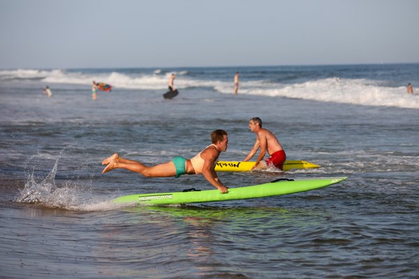 A Westhampton lifeguard heads into the surf.