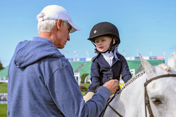Young Landry Donahue of Westhampton gets quizzed by judge Joe Fargis during her leadline competition for 2 to 4 year olds at Opening Day at the Hampton Classic on Sunday.