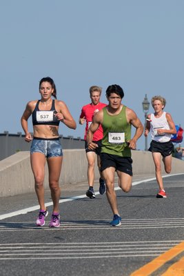 Paige Duca (overall champion) and Oscar Lorenza (second place) and the rest of the lead pack run over LCPL Jordan C. Haerter Veterans' Memorial Bridge during the third annual Jordan’s Run 5K.