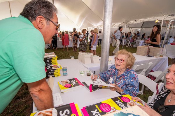 Dr. Ruth Westheimer signs a copy of her book Sex for Dummies for Len Benowich during the East Hampton Library's 15th Annual Authors Night Benefit under the tent at 555 Montauk Highway in Amagansett on Saturday.