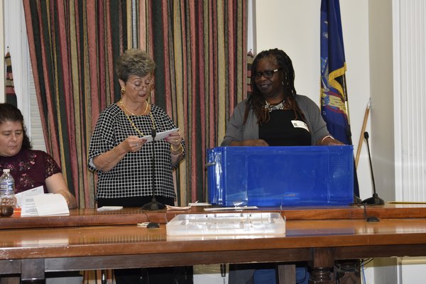 Southampton Town Director of Housing & Community Development Diana Weir reads the names of affordable housing applicants, picked at random by Bonnie Cannon, the chair of the Southampton Housing Authority.
