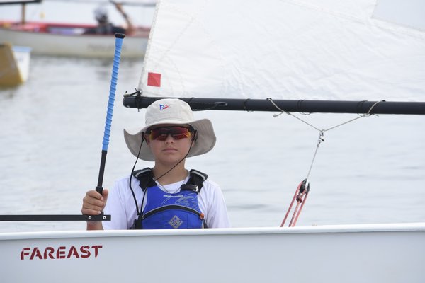 Charlie Caporrino of Pequot Yacht Club waits for opti races to start.