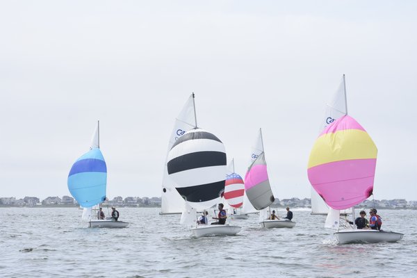 The 420s let their spinnakers fly.