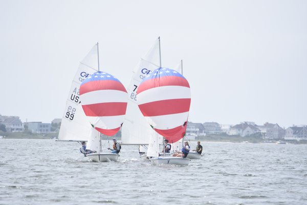 The 420s let their spinnakers fly.