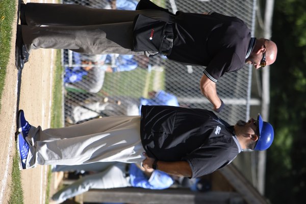 Southampton Breaker manager Rob Cafiero shares a laugh with an umpire in between innings of a game on June 23.