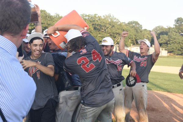 Logan Verrino (Florida Southern) douses manager Alex Brosnan with water in celebration of Tuesday's victory.