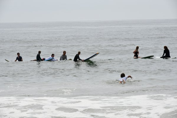 Surfers at Agawam Beach in Southampton Village on Sunday.   DANA SHAW