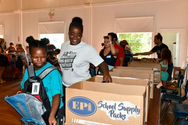 Volunteers fill backpacks at the Bridgehampton Community House on August 22.  DANA SHAW