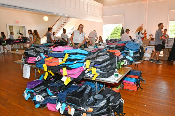 Volunteers fill backpacks at the Bridgehampton Community House on August 22.  DANA SHAW