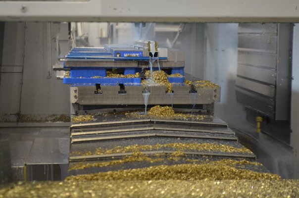 A brass piece being made in a 3-axis computer numerical control, or CNC, machine. ANISAH ABDULLAH