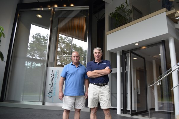 Westhampton Architectural Glass owners Paul Siller and Bob Busking in the showroom. ANISAH ABDULLAH