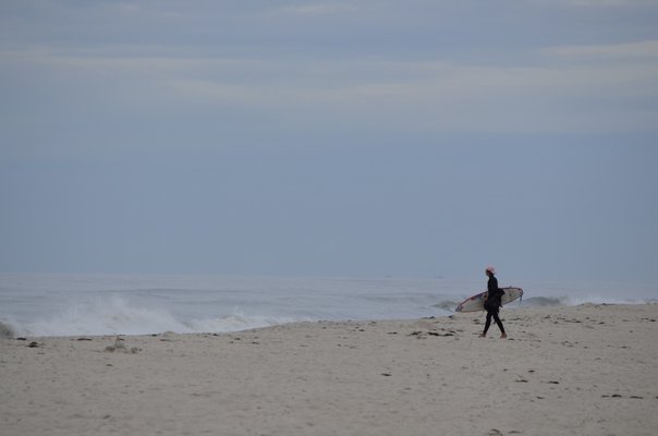 A surfer at Lashley Beach in Westhampton Beach, known as Jetty 4. ANISAH ABDULLAH