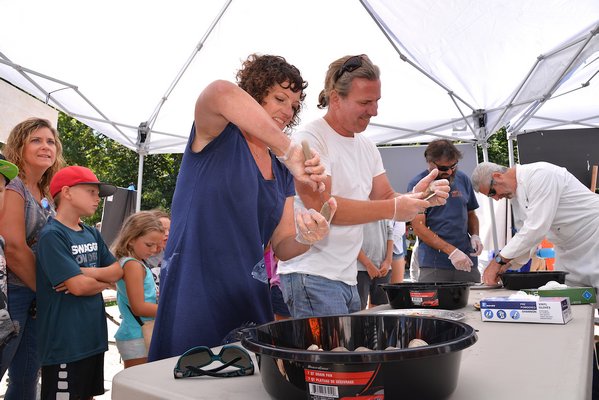 Meredith O’Leary and Jack Dougherty went tooth and nail in the Clam-shucking contest.  KYRIL BROMLEY