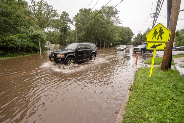 Flooding on Springs-Fireplace Road at Gardiner Avenue on Tuesday.  MICHAEL HELLER