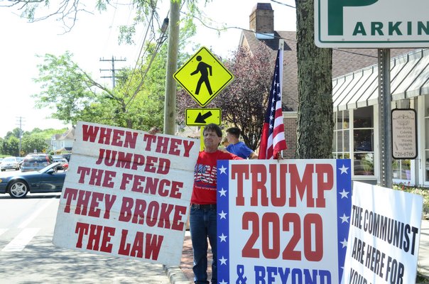 President Trump protesters and supporters lined Montauk Highway in Water Mill on Friday, in anticipation that he would eventually drive by. GREG WEHNER