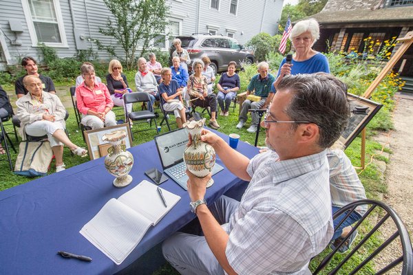 Black Swan Antiques proprietor Randy Kohloff examines one of two Japanese vases - estimated to be from the 1800s, and conservatively estimated to be worth $1,000 each - brought in by Mary Lane during the Family Heirloom Appraisal event hosted at the Annie Cooper Boyd House by the Sag Harbor Historical Society on Friday.    MICHAEL HELLER