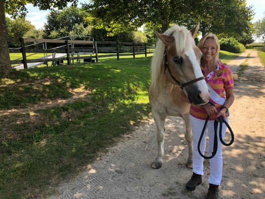 Karen Bocksel, CTREE's managing director/instructor, with Moseley, one of the horses in the program, at Wolffer Estate Stables.