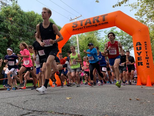 Kal Lewis, front and center at the start of Sunday's Ellen's Run 5K, finished first overall despite a pair of missed turns on a hot and humid day on the roads around Stony Brook Southampton Hospital.