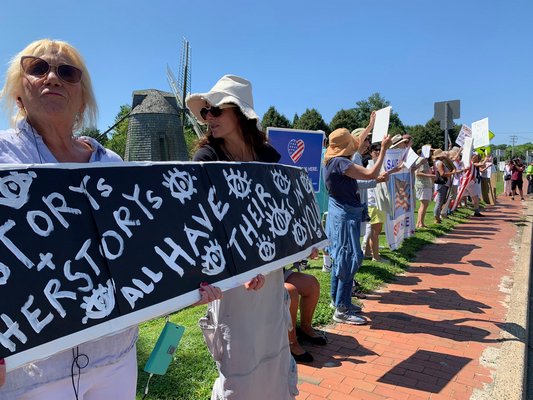 Protesters on the Water Mill Village Green on Friday during President Donald Trump's visit to the Hamptons.  KIM COVELL