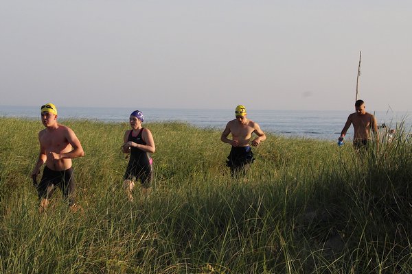 Triathletes head onto shore during the Montauk Lighthouse Sprint Triathlon.