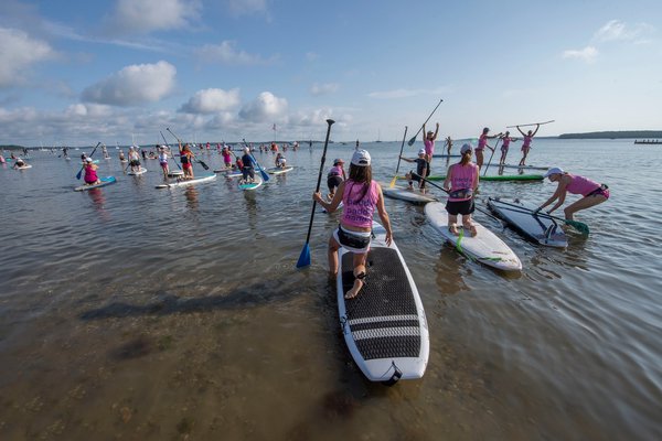 Paddlers make their way to the starting line during the annual Paddle for Pink at Havens Beach on Saturday morning.