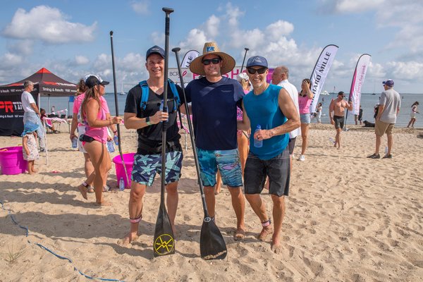 3-Mile Third Place Winner Simon Davey, First Place Winner Chris Hanson (with a time of 38:59) and Second Place Winner Ari Weller during the annual Paddle for Pink at Havens Beach on Saturday morning.