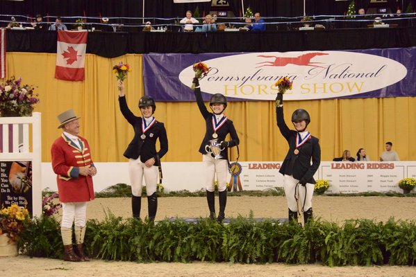 Sophie Gochman receiving her gold medal after winning the 2018 USEF Junior Jumper National Championship (Prix des States) at the Pennsylvania National Horse Show in Harrisburg.