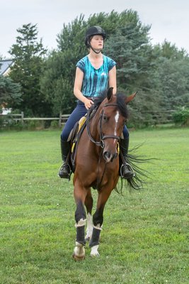 Phoebe Topping trains for competition at the Hampton Classic with her mount John Courage at the Swan Creek Farm Stables.