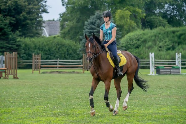 Phoebe Topping trains for competition at the Hampton Classic with her mount John Courage at the Swan Creek Farm Stables in Bridgehampton on Tuesday, 8/13/19