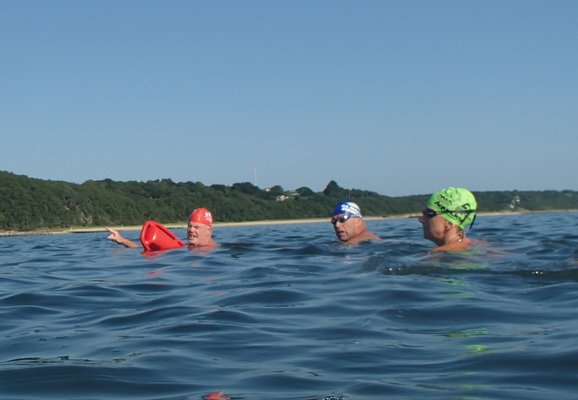 Coach Tim Treadwell explains the next swim course and “sighting” tricks to prevent wandering off course.
