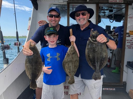Three generations of Elliots-Ryan, Ryan and Don-from East Quogue with their haul of fluke from a Sunday aboard the Shinnecock Star.