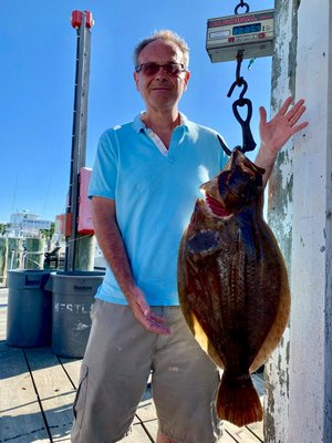 George Kok decked this nearly 14-pound fluke while fishing aboard the Mishell II charter boat out of Montauk  last weekend.