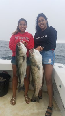 Shelby Bharrat and Bianca Khargie with a couple of nice striped bass they caught while fishing aboard the Blue Fin IV charter boat out of Montauk recently.