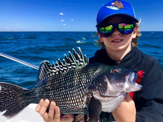 Finding a few keeper black sea bass, like this one Jake Calloway caught last week, is a key to filling the cooler off Shinnecock these days since the number of keeper fluke has faded considerably.