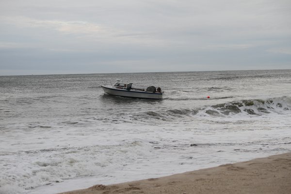 A commercial fishing boat setting a gillnet off the beach in Bridgehampton.
