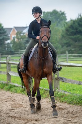 Lucy Beeton trains in the rain for competition at the Hampton Classic at the Swan Creek Farm Stables in Bridgehampton on August 13.