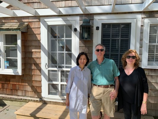 Sylvia Wong, left, who works at the firm that recently bought The Gansett Green Manor stands with Jed and Leslie Feldman, previous owners.        BEN KAVA