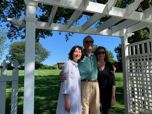 Sylvia Wong, left, who works at the firm that recently bought The Gansett Green Manor stands with Jed and Leslie Feldman, previous owners. BEN KAVA