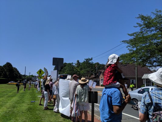 Protesters greet drivers on Montauk Highway in Water Mill.