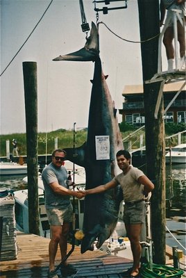 Tred Barta, right, and Jim Hummell with the 892 pound mako shark they caught in 1986.