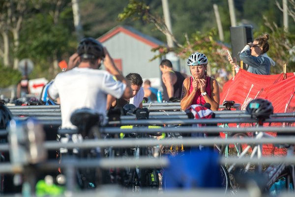 Competitors switch from swimming gear to biking gear in the transition area.